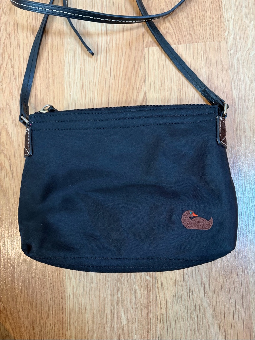 Dooney and Bourke Black Crossbody Bag with Magenta Interior